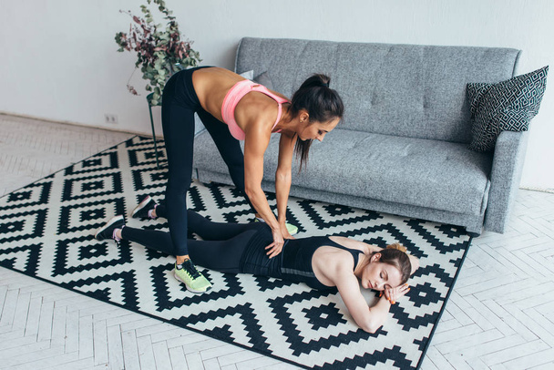 Woman massages her friends back after workout - Valokuva, kuva