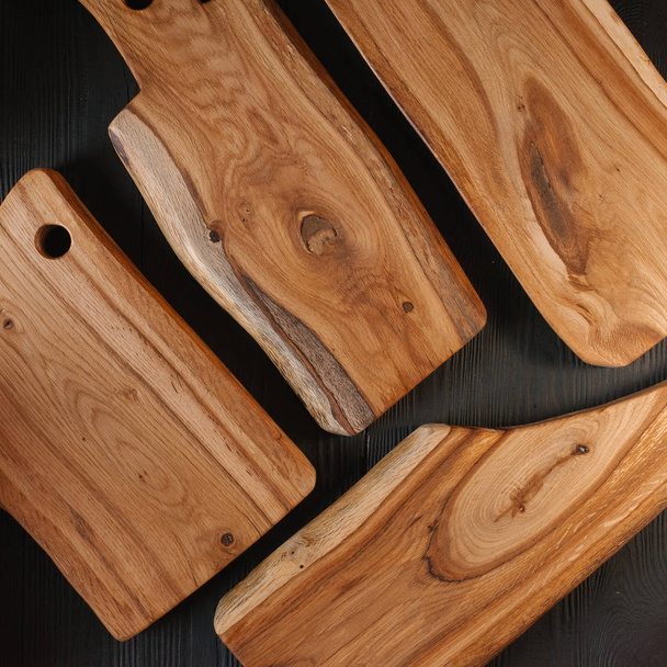 Wooden chopping boards on black wooden background - Photo, Image