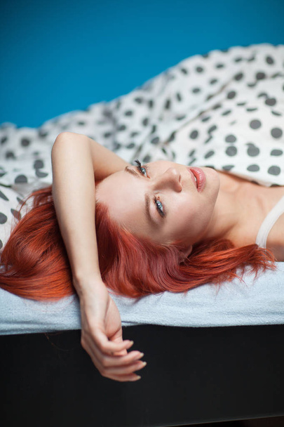 beautiful woman with red hair lying in bed at home, waking up in the morning.  - Foto, Imagem