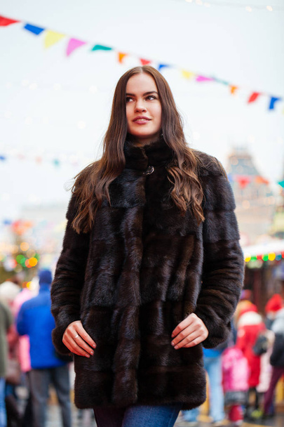 Portrait of a Young beautiful woman in blue fur coat, posing in winter Red Square in central Moscow - Fotografie, Obrázek