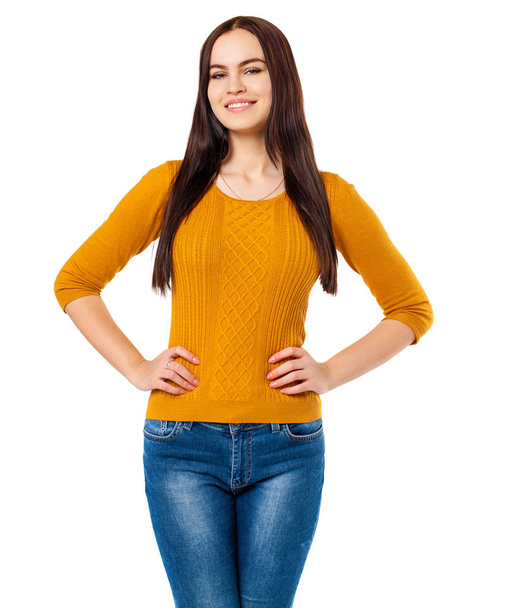 Happy brunette woman in blue jeans and mustard sweater, isolated on white background - Zdjęcie, obraz