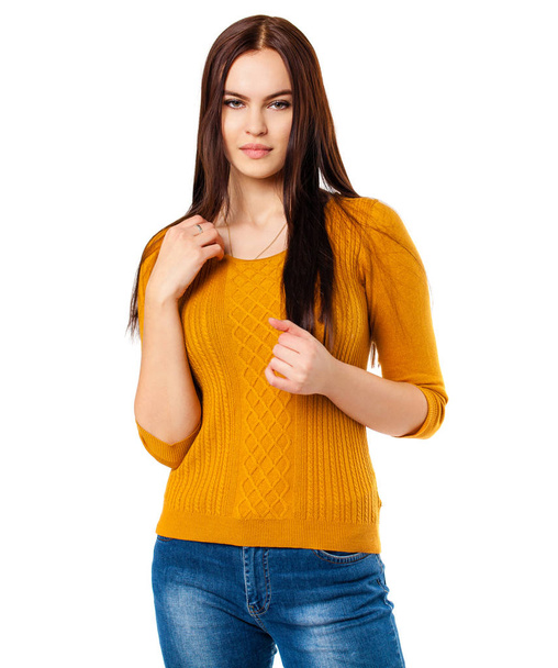 Happy brunette woman in blue jeans and mustard sweater, isolated on white background - Фото, зображення