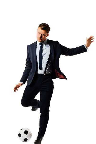 young handsome businessman manager kicking a soccer ball on white background isolated. - Zdjęcie, obraz