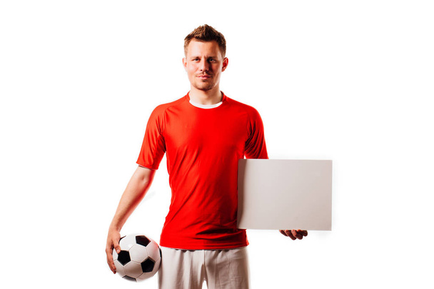 Young handsome football player soccer holds ball and white blank on white. - Foto, immagini