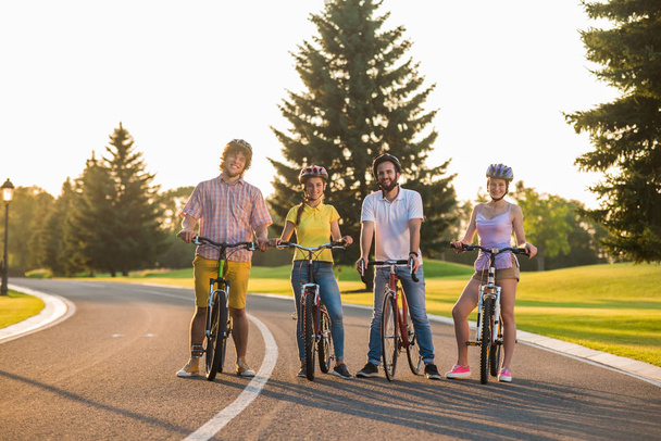 Group of happy friends with bicycles outdoors. - Foto, Imagen