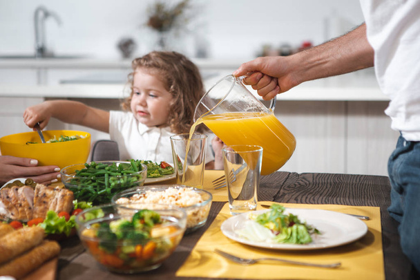 Cheerful dad serving healthy drink for his daughter  - 写真・画像