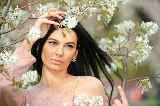 Close up romantic portrait of beautiful elegant woman in blossom spring trees. - Фото, зображення