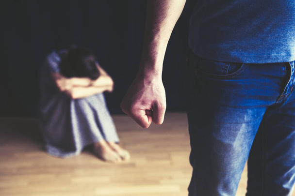 Scared woman protecting from mans aggression. Domestic violence concept - Φωτογραφία, εικόνα