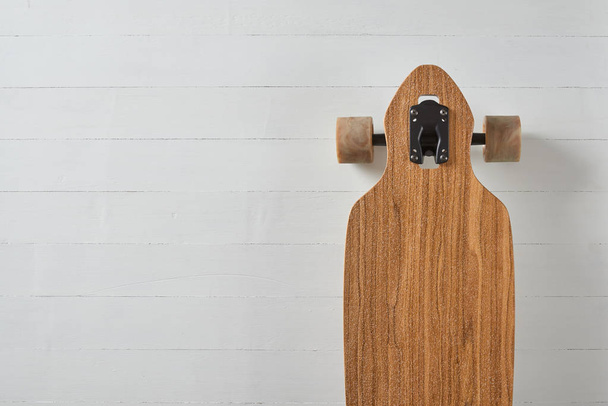 wood pattern drop through type pintail longboard on a white deck background - Foto, Imagen