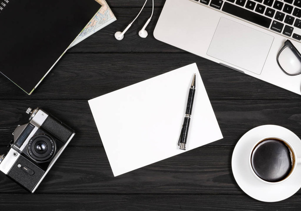 coffee, computer camera, notebook and pen on a black background - Φωτογραφία, εικόνα