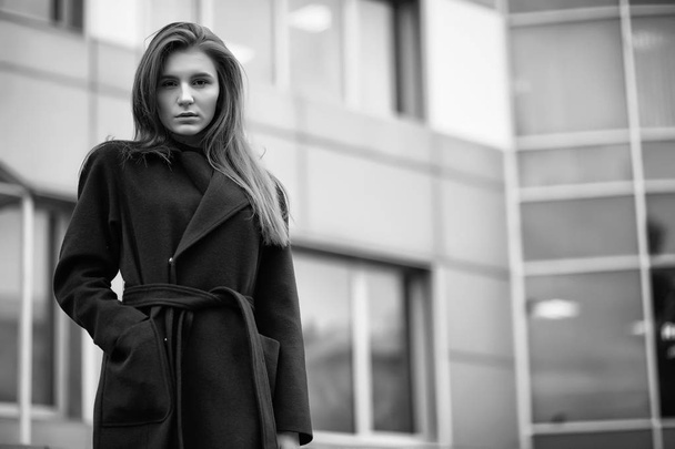 Girl in a coat black and white photo - Foto, Imagen
