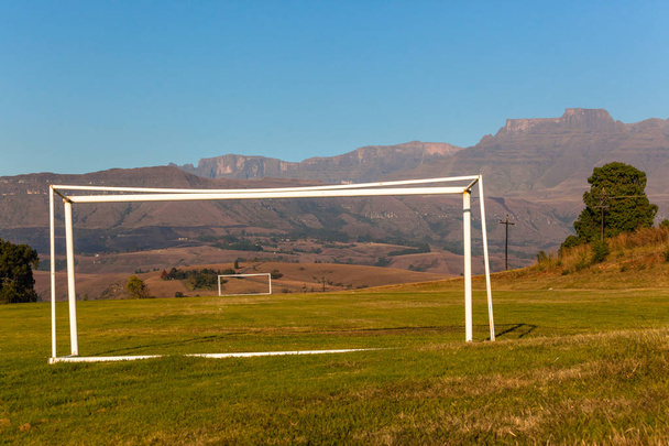 Ποδόσφαιρο Ποδόσφαιρο γκολ πόλους στα Drakensberg βουνά νωρίς το πρωί το φθινόπωρο πέφτουν χρώματα ψάχνει σαμπάνια κάστρο βουνό και κοιλάδα ένα γραφικό τοπίο - Φωτογραφία, εικόνα