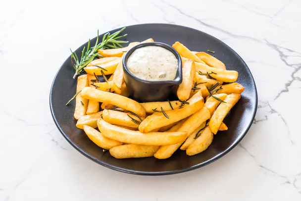 french fries with sauce - unhealthy food - Foto, immagini