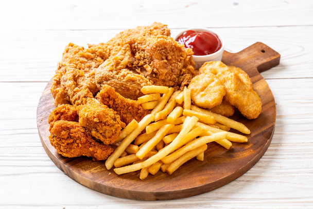 fried chicken with french fries and nuggets meal - junk food and unhealthy food - Фото, изображение