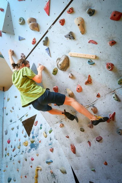 Teenage Boy Training Climbing On Indoor Climbing Wall - Photo, Image