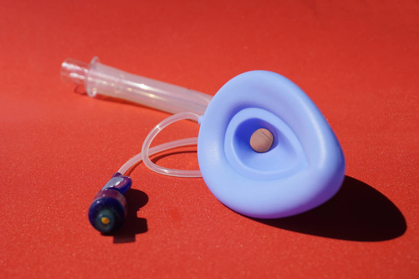 Laryngeal mask airway for emergency medical help on a red backgroun - Photo, Image
