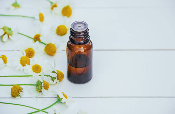 Chamomile extract in a small bottle. Selective focus.  - Photo, Image