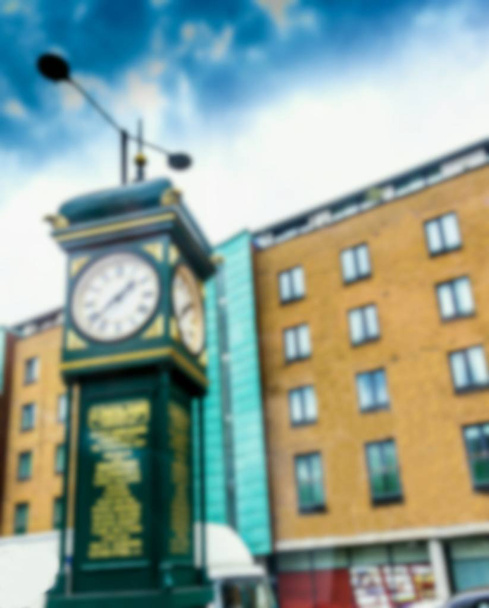 Blurred view of J. Smith and Sons Clock located on a pedestrian island between Goswell Road and City Road in Islington . London . J.Smith & Sons - famous clockmakers family - Photo, Image