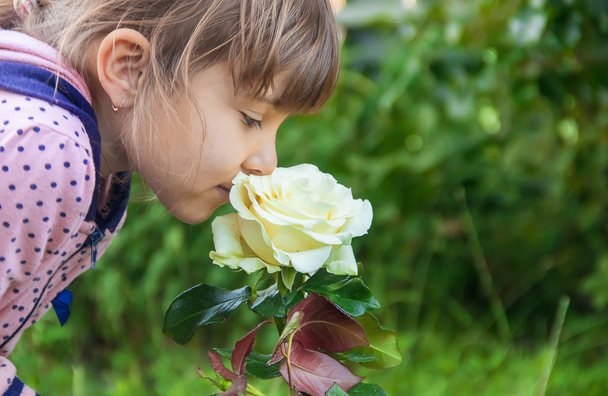 children girl with roses in the garden. selective focus.  - Fotografie, Obrázek