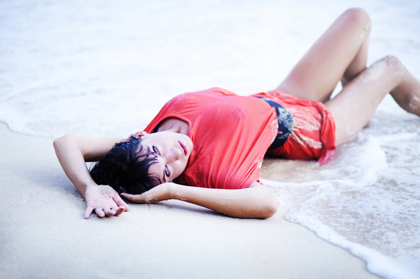 Young beautiful brunette woman on the beach - Fotó, kép