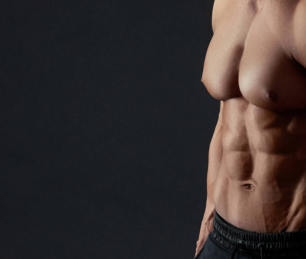Muscular torso of male bodybuilder. - Photo, image