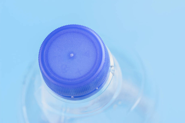 Plastic bottles of water close-up on blue background - Фото, зображення