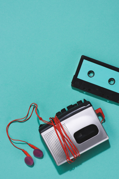 flat lay with retro audio cassette, cassette player and earphones isolated on blue - Photo, Image