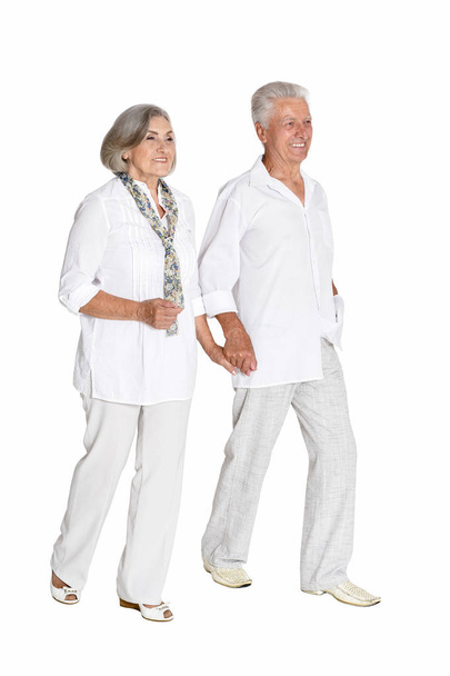 Full length portrait of  senior couple holding hands   isolated on white background - Foto, imagen