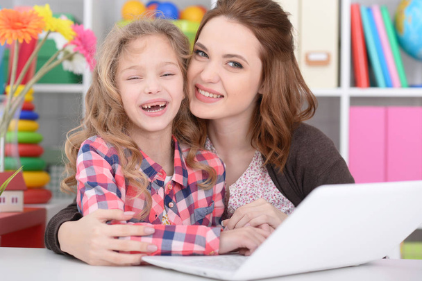 mother and daughter using laptop - Photo, image