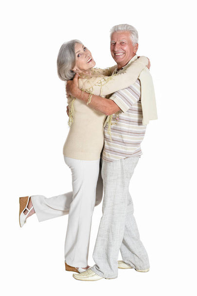 Portrait of beautiful senior couple dancing   isolated on white background - Foto, afbeelding