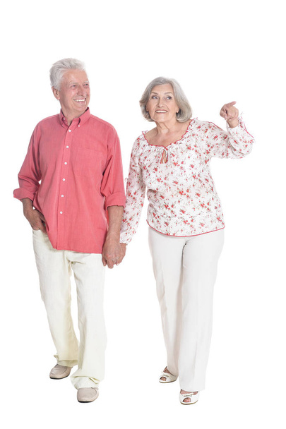 Full length portrait of  senior couple holding hands   isolated on white background - Zdjęcie, obraz