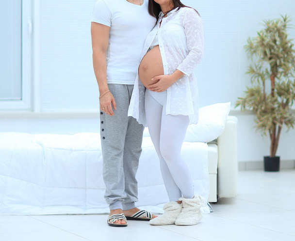 closeup.a pregnant woman and her husband standing in the new apartment. - Φωτογραφία, εικόνα