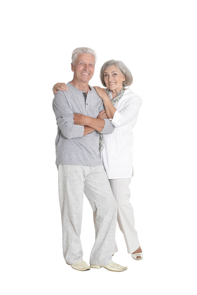 Full length portrait of  senior couple embracing  isolated on white background - 写真・画像