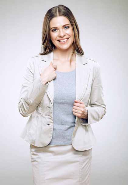 Smiling businesswoman wearing office suit posing isolated on white background - Fotó, kép