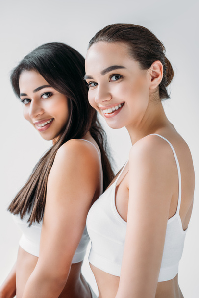 smiling attractive multicultural women posing isolated on gray background  - Φωτογραφία, εικόνα