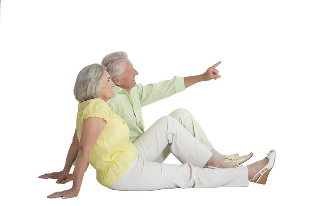 portrait of  senior couple showing something   isolated on white background, full length - Photo, Image