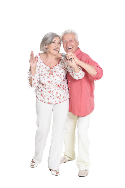 portrait of  senior couple singing  isolated on white background, full length - 写真・画像