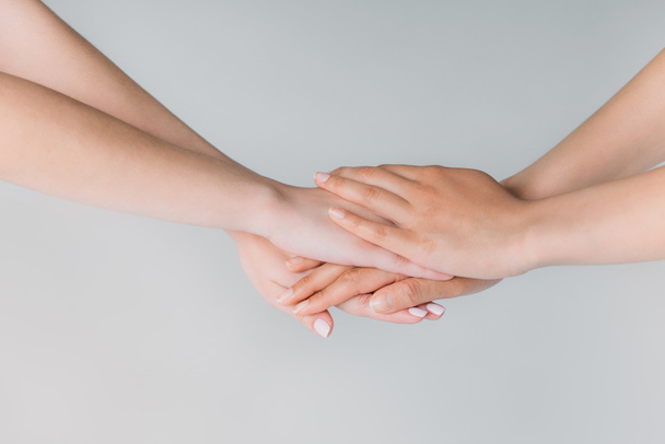 partial view of women holding hands, isolated on grey, togetherness concept - Photo, Image