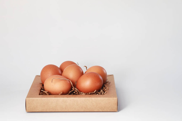 Chicken brown eggs on a white table - Photo, image