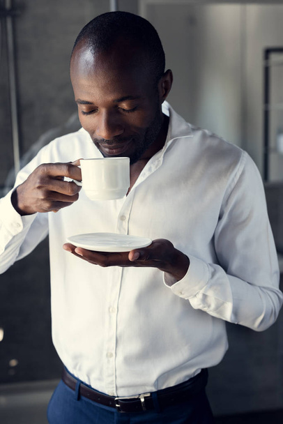 handsome young businessman in white shirt enjoying cup of coffee - Φωτογραφία, εικόνα