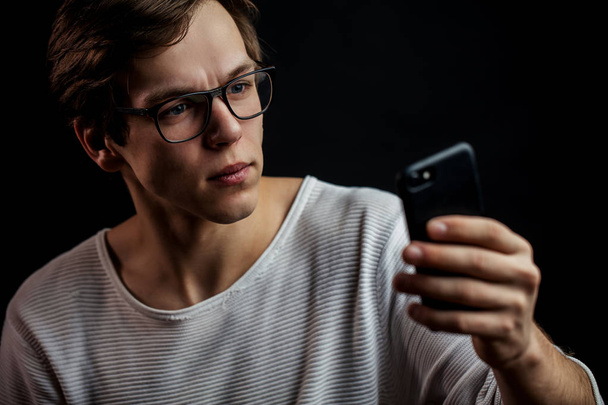 close up portrait of pleasant programmer with mobile phone. - Фото, изображение