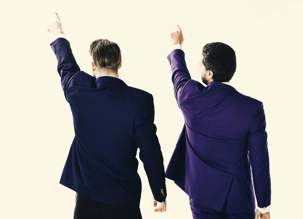 business partners. Men in suit or businessmen raise hands - Foto, afbeelding