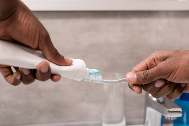 cropped shot of man applying toothpaste onto brush  - Фото, зображення