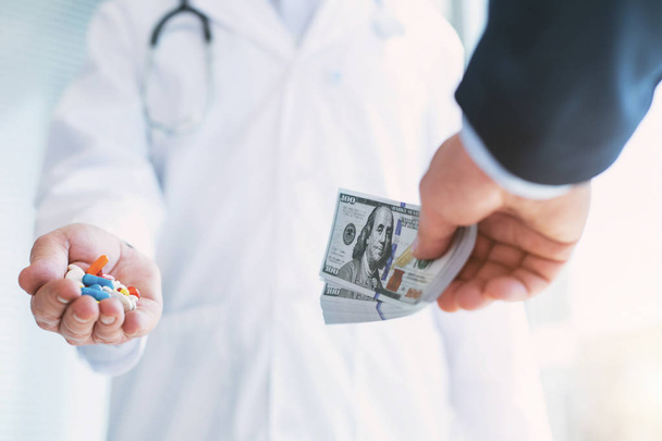 Dishonorable doctor taking money for medication - Φωτογραφία, εικόνα
