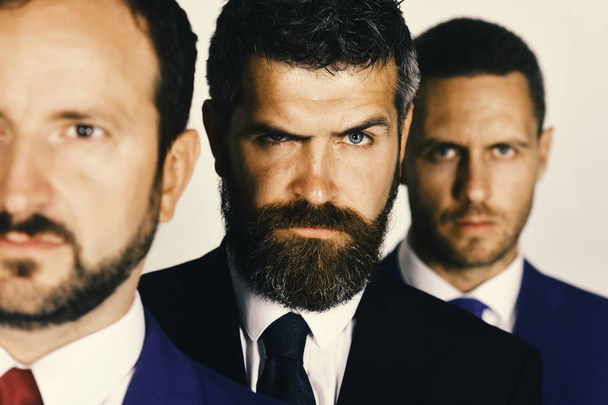 serious faces. Conflict and business concept. Businessmen wear smart suits - Фото, зображення