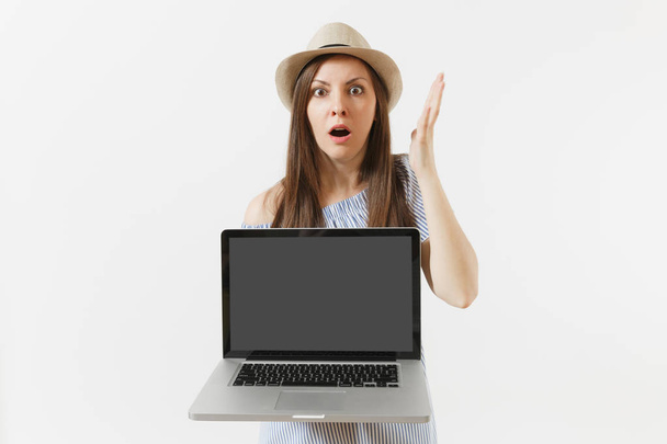 Shocked woman holding modern laptop pc computer with blank black empty screen to copy space isolated on white background. People freelance business, lifestyle, online shopping concept. Mobile Office - Foto, Bild