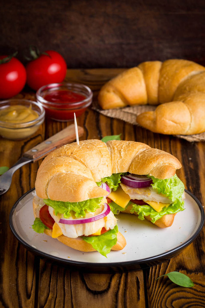 Croissant sandwich with chicken, vegetables, cheese, tomato, onion, delicious healthy lunch - Fotografie, Obrázek
