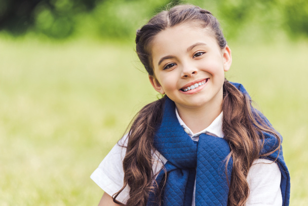 close-up portrait of beautiful schoolgirl in stylish clothes in park - Zdjęcie, obraz