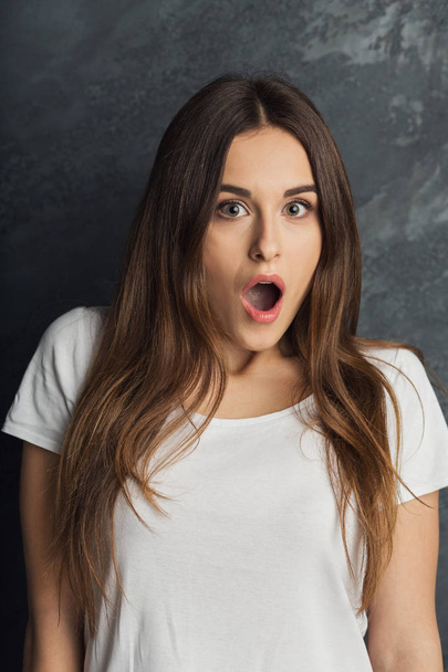 Shocked woman covering mouth with hands - Photo, Image