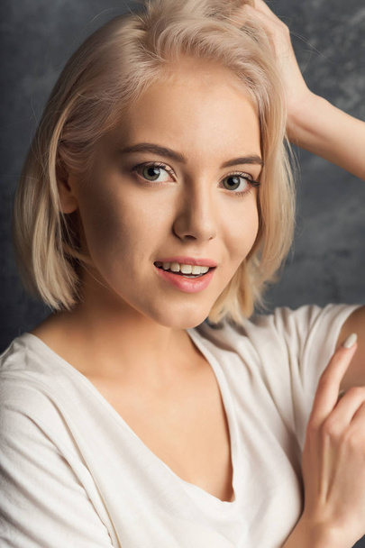 Young woman studio headshot portrait on dark background - Photo, Image